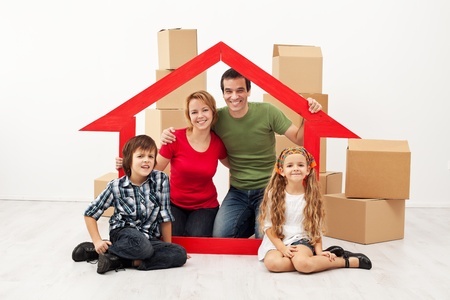 19505419 - happy family with kids moving into a new home - sitting with cardboard boxes